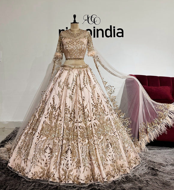 CHAMPAGNE GOLD LEHENGA WITH FEATHER CAPES