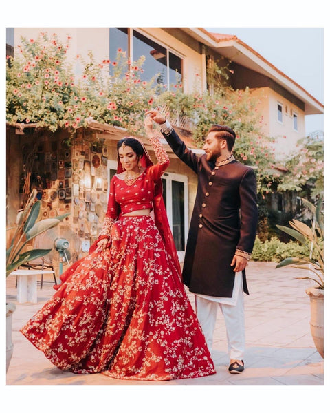 Indian Bride And Groom In A Coordinated Maroon Velvet Wedding Lehenga And  Sherwani | Indian wedding lehenga, Indian bride and groom, Sherwani